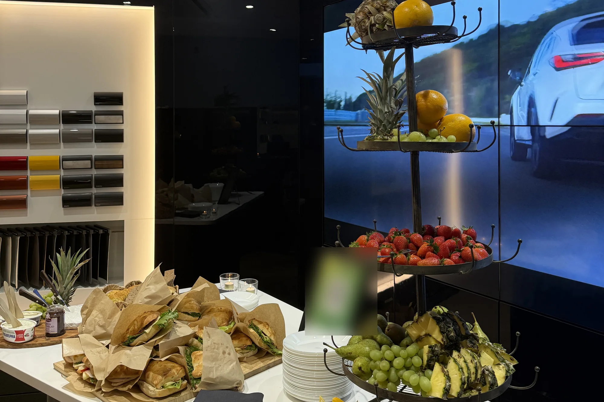 Frukostbuffé med smörgåsar och fruktfat i Lindströms Bils showroom